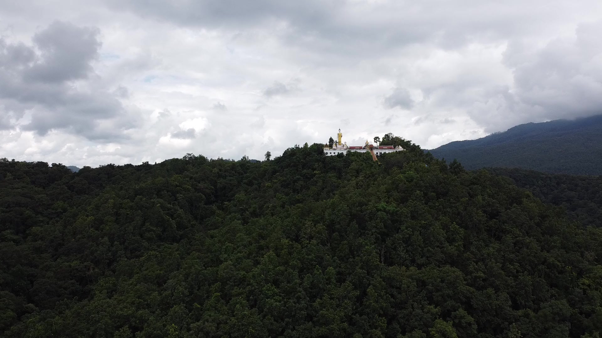 Wat Phra That Doi Kham above the green hills of Chiang Mai